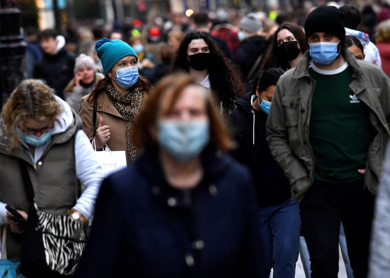 People wear protective face masks while out for Christmas shopping