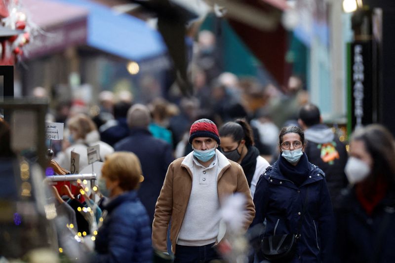 People wearing face masks are seen on a Paris street