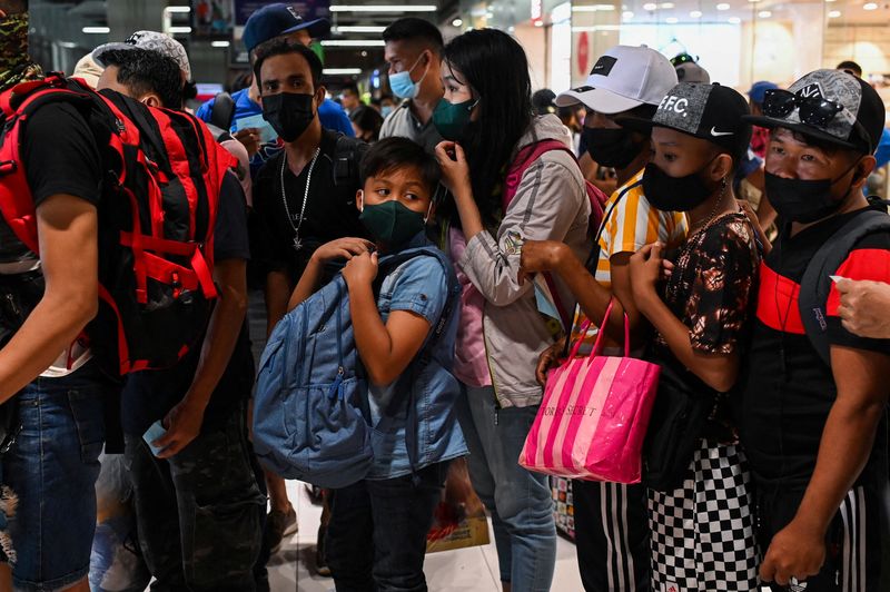 Filipinos wait for bus heading to provinces ahead of New
