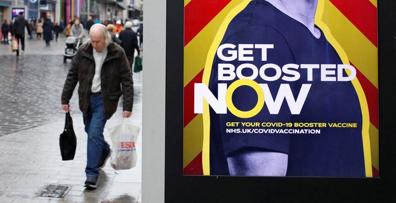 A man walks past an advertising board encouraging people to