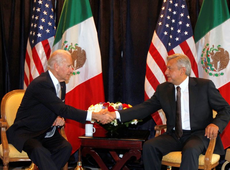 FILE PHOTO: Then-U.S. vice president Joe Biden (L) shakes hands