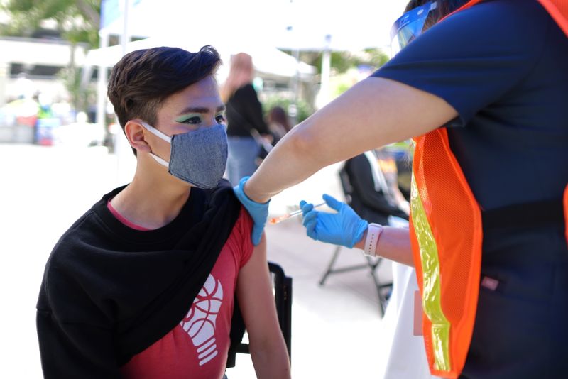 Diego Cervantes, 16, receives a coronavirus disease (COVID-19) vaccination at