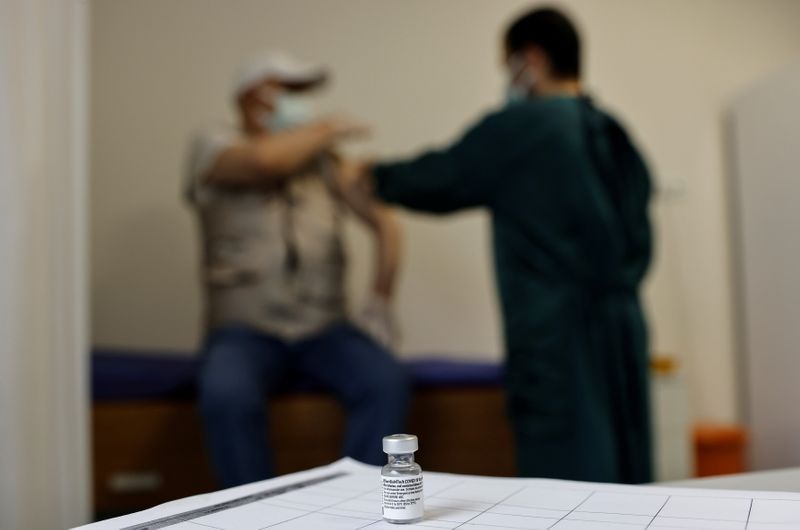 A man receives a shot of the Pfizer-BioNTech coronavirus disease