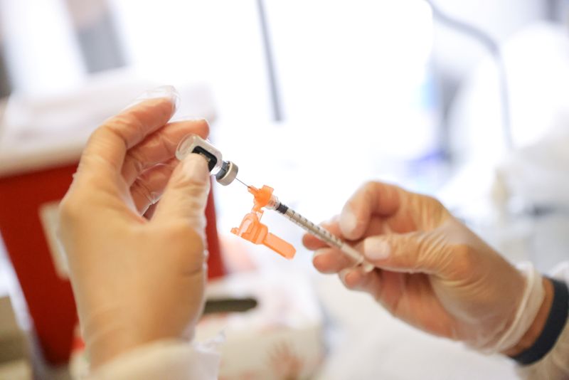 A COVID-19 vaccine dose is prepared at the American Museum