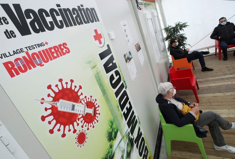 A woman sits at a COVID-19 vaccination centre, in Ronquieres