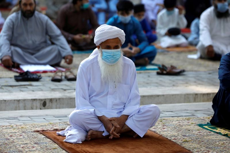 FILE PHOTO: Muslims celebrating Eid al-Fitr as the outbreak of