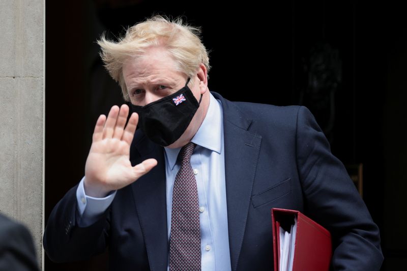Britain’s PM Johnson walks leaves Downing Street in London