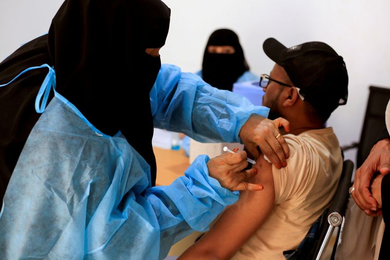 FILE PHOTO: A man receives the AstraZeneca vaccine against the