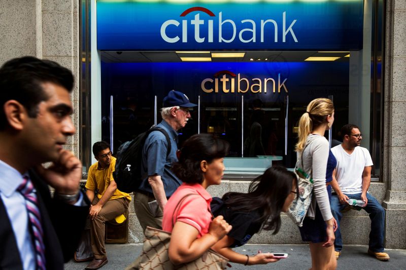 FILE PHOTO: Pedestrians walk past the facade of a Citibank
