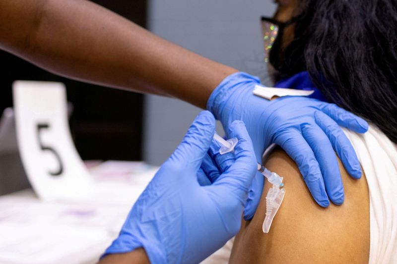 FILE PHOTO: A woman receives a COVID-19 vaccine at a
