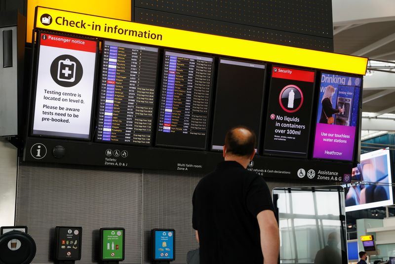 FILE PHOTO: A man looks at a check-in information board