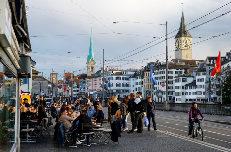 FILE PHOTO: Guests sit outside of a restaurant in Zurich