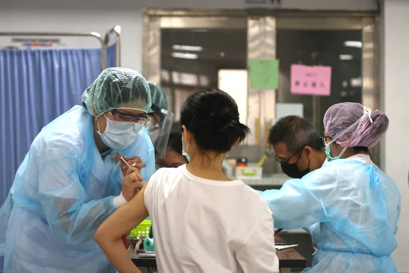 A nurse administers a dose of the AstraZeneca vaccine against