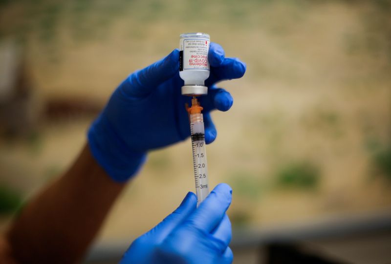 A healthcare worker prepares the Moderna vaccine against the coronavirus