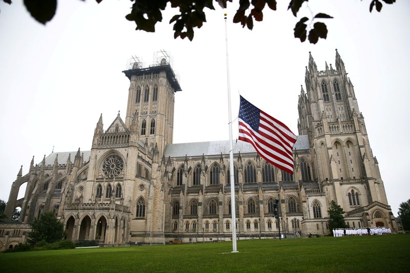 FILE PHOTO: A flag flies at half staff in front