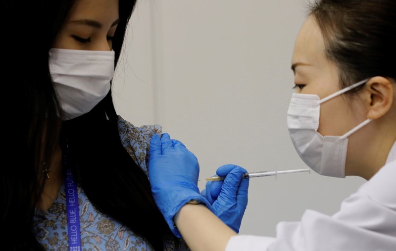 A staff of All Nippon Airways (ANA) receives a dose