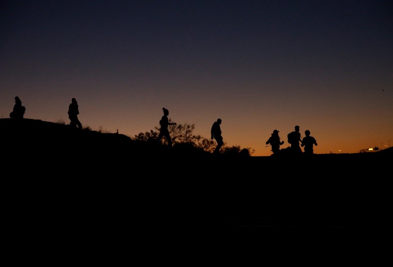 FILE PHOTO: Asylum-seeking migrants are seen before crossing the Rio