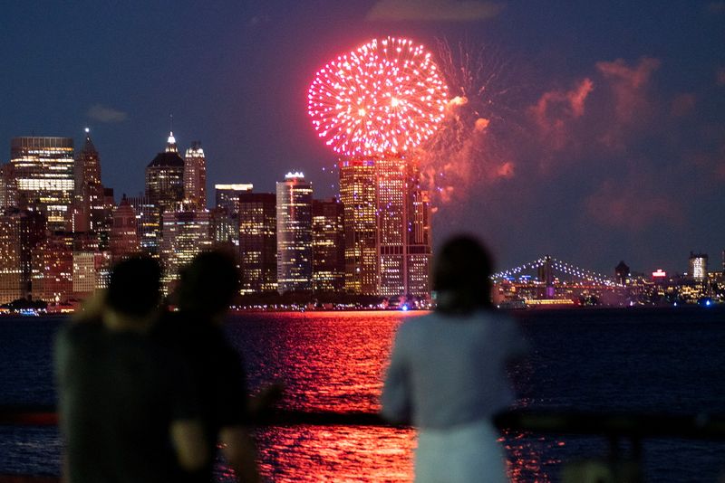 Fireworks are seen in the New York City Harbor, as
