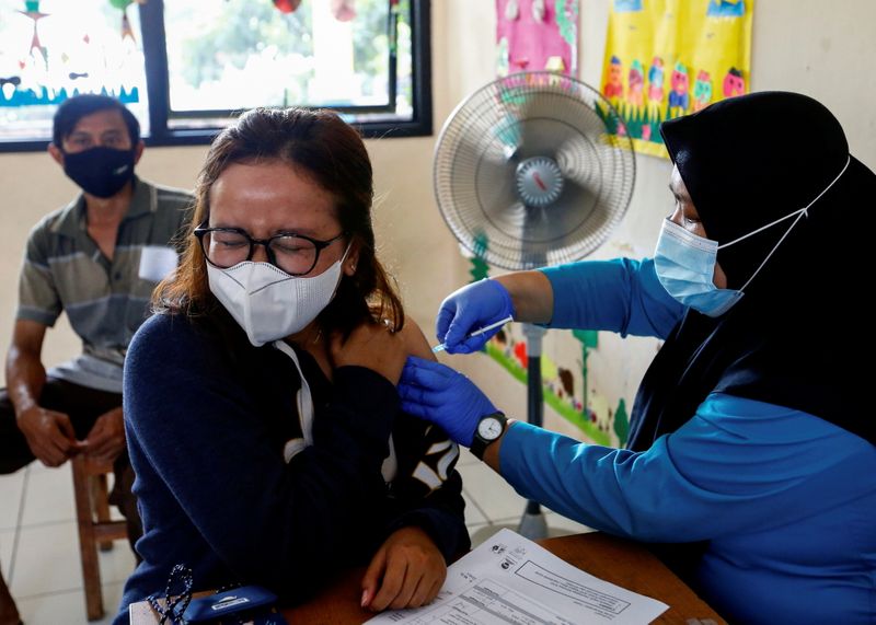 FILE PHOTO: A woman wearing a protective mask reacts as