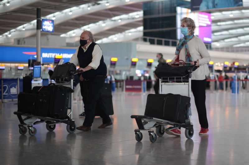 Passengers walk at the Terminal 5 departures area at Heathrow
