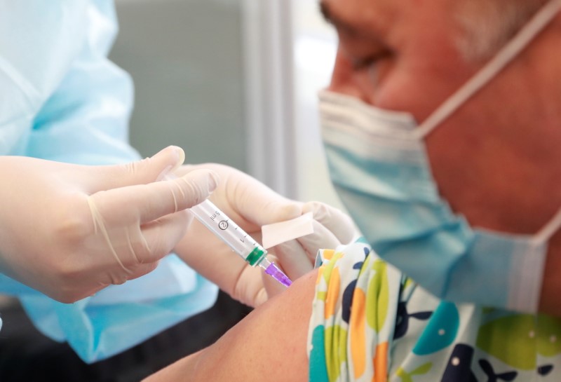 A patient receives a dose of COVID-19 vaccine at a
