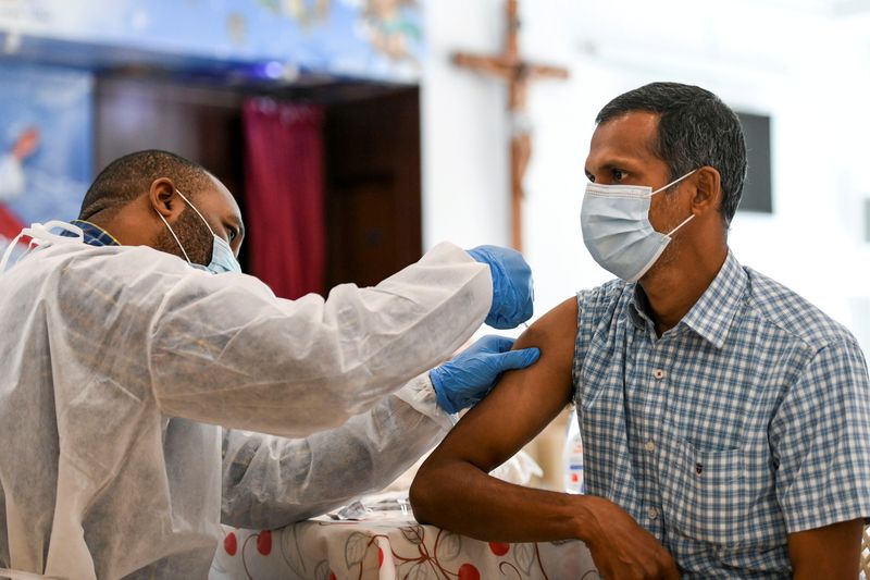 FILE PHOTO: A man receives a dose of a vaccine