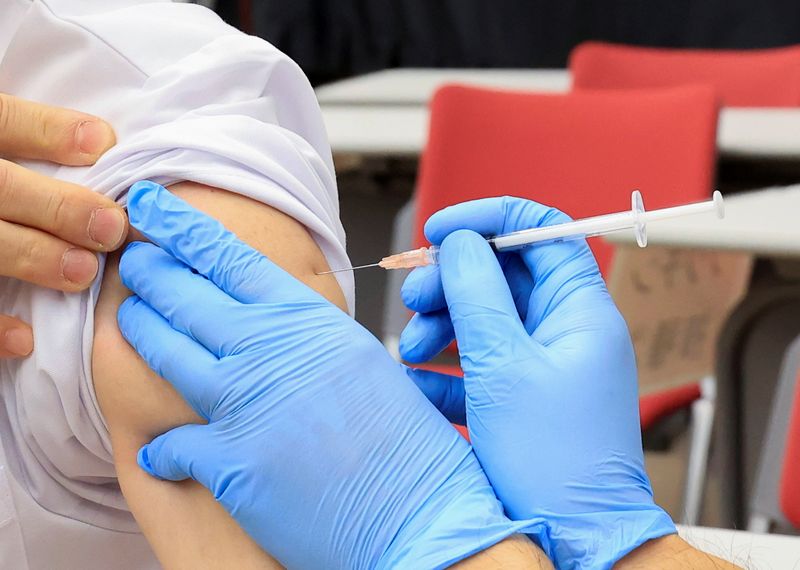 Medical workers receive doses of the vaccine against the coronavirus