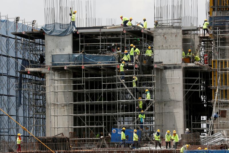 FILE PHOTO: Labourers work at a construction site in downtown