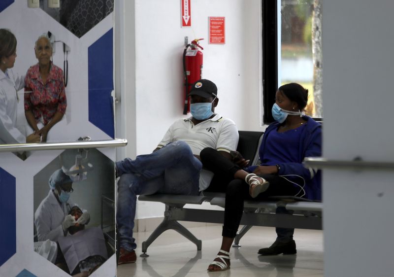 FILE PHOTO: People wear face masks inside a military hospital
