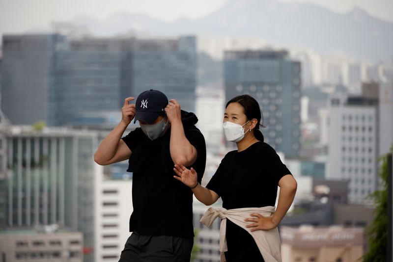 A couple wearing masks to avoid contracting the coronavirus disease
