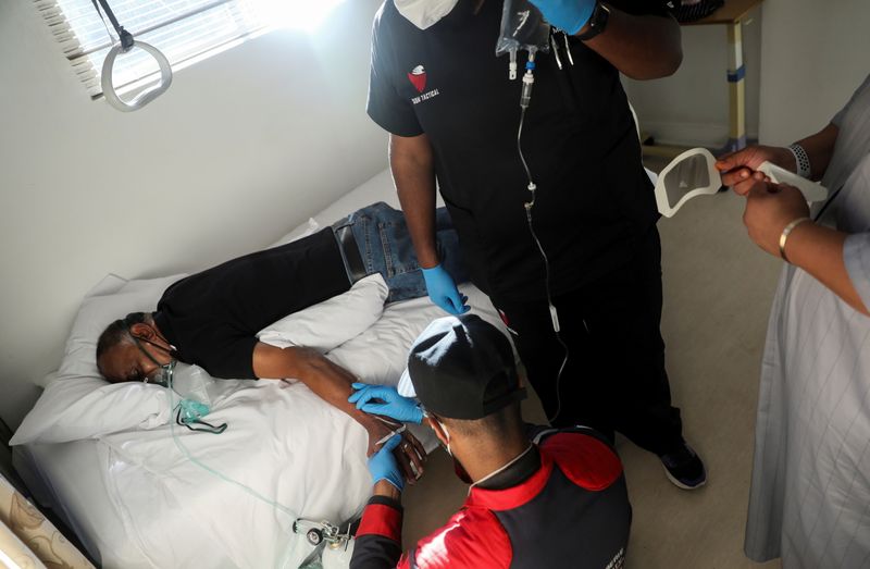 FILE PHOTO: Paramedics attend to a patient at the MASA