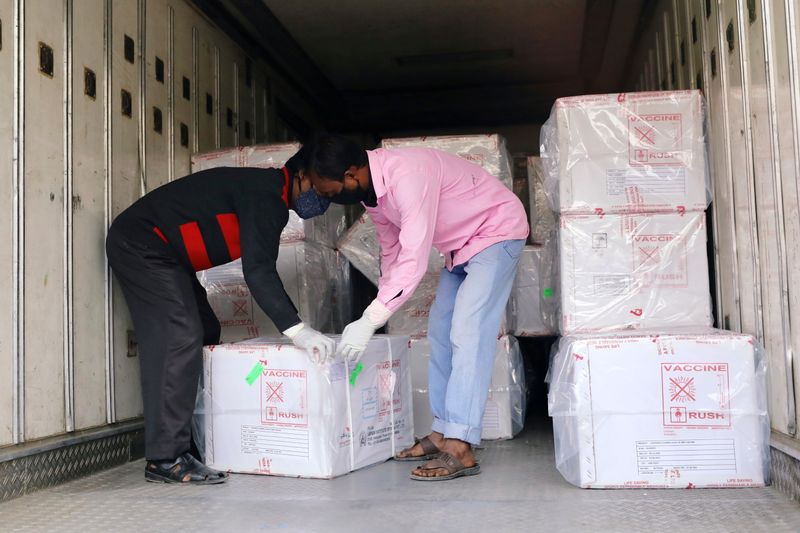 Workers unload a pickup van that carries Oxford-Astrazeneca COVID-19 vaccines