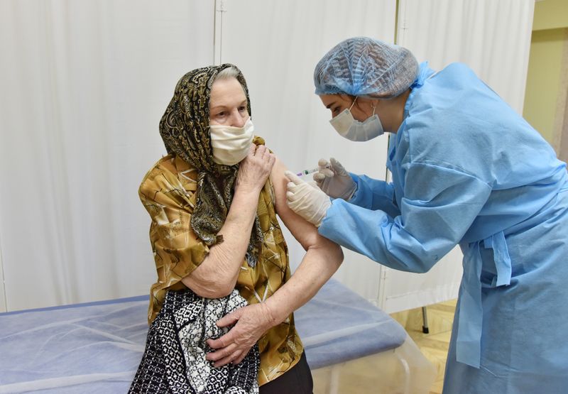 FILE PHOTO: An elderly woman receives the COVID-19 vaccine in