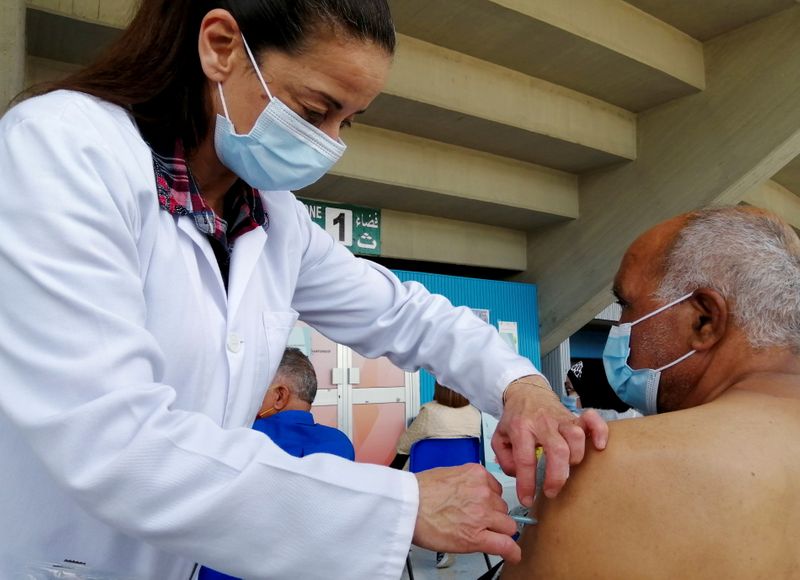 FILE PHOTO: A man receives a COVID-19 vaccine in Tunis