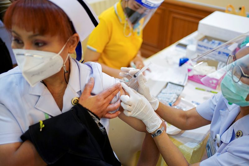 FILE PHOTO: A health worker receives the Sinovac coronavirus disease