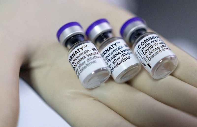 FILE PHOTO: A doctor shows vials of Biontech-Pfizer’s Comirnaty vaccine