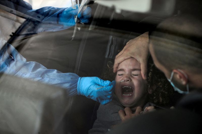 FILE PHOTO: A girl is tested for the coronavirus disease