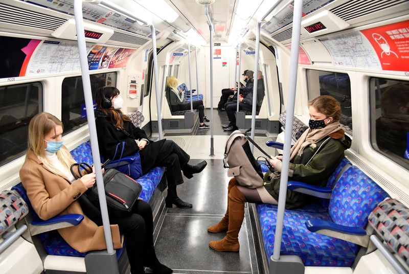 Workers travel on a Jubilee Line underground train during the