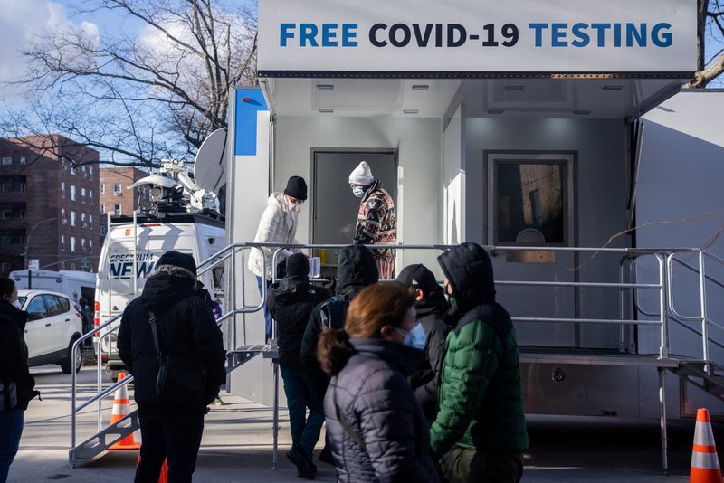 People queue at a popup COVID-19 testing site in New