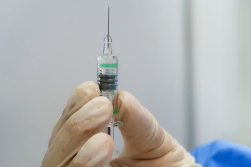 FILE PHOTO: A nurse holds a syringe containing a coronavirus