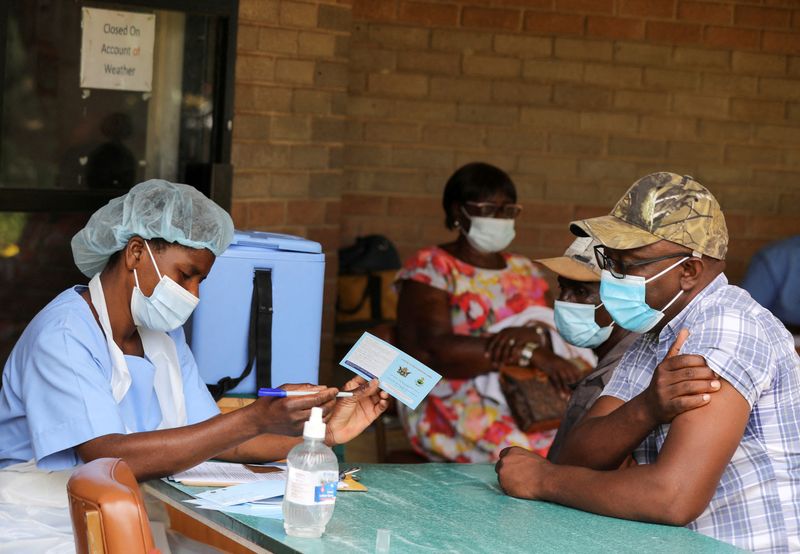 FILE PHOTO: A man receives a certificate after being vaccinated