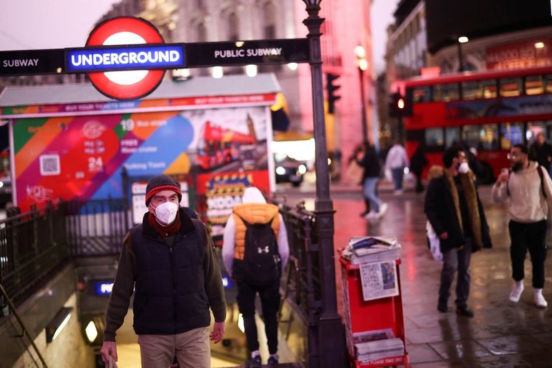 People exit Piccadilly Circus underground station, amid the coronavirus disease