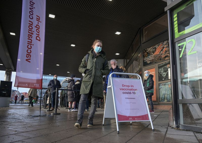 People queue for a drop-in vaccination at Stockholm City Terminal
