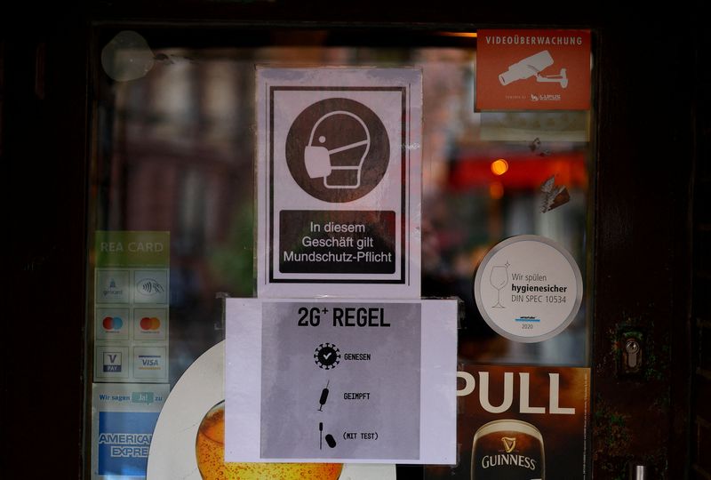Signs show requirements to enter restaurants and bars as the