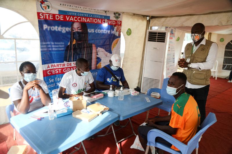 FILE PHOTO: Abidjan soccer fans get the vaccinated against the