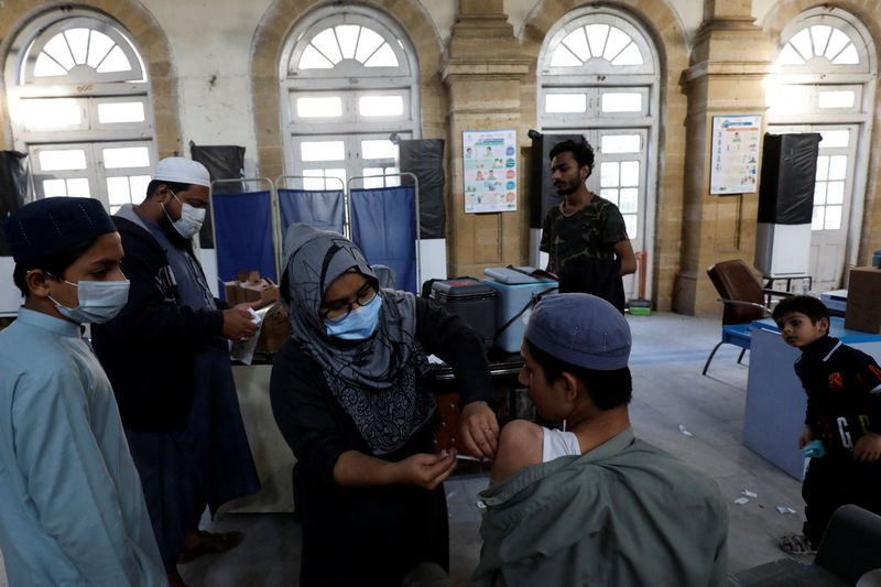 COVID-19 vaccine is administered at a vaccination centre, in Karachi