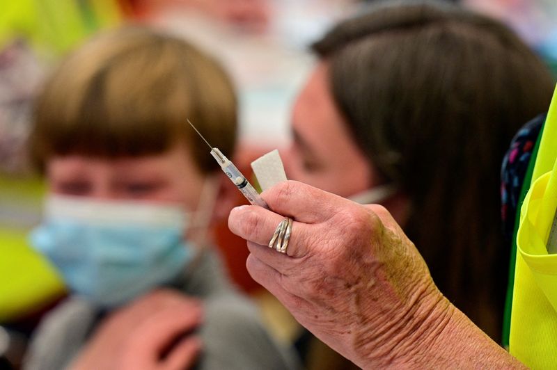 FILE PHOTO: Children age 5 to 11 receive COVID-19 vaccines
