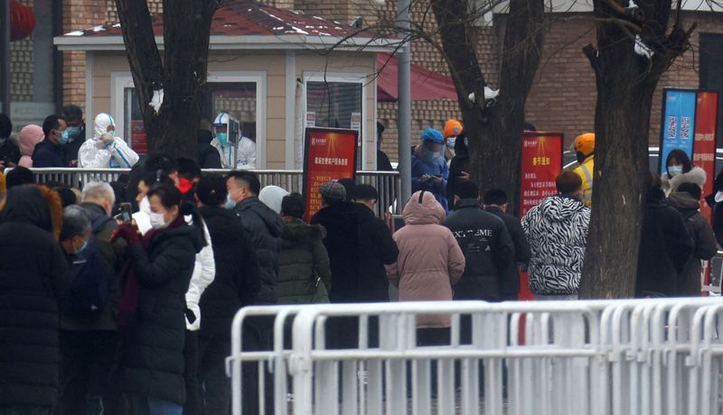 FILE PHOTO: People queue at a nucleic acid test street