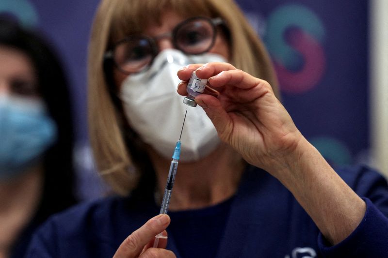FILE PHOTO: A nurse prepares a fourth dose of coronavirus