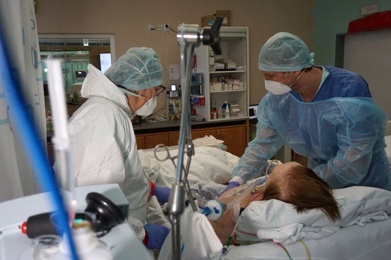 FILE PHOTO: Medial personnel attend a patient suffering from the
